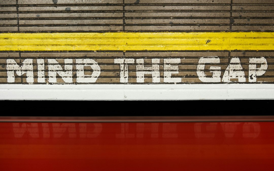 A sign that says mind the gap on the side of a train
